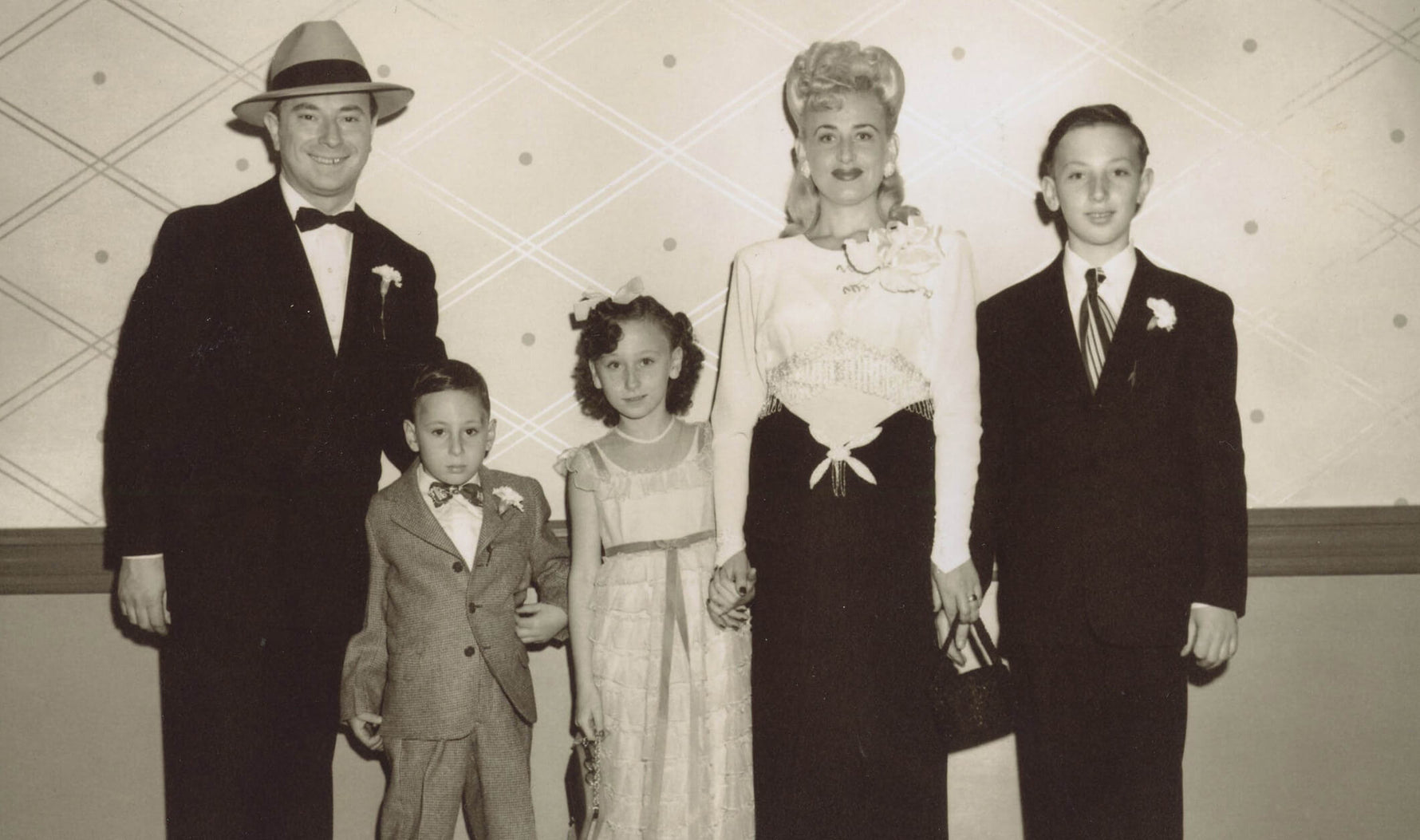 Black and white photo of family posing for portrait 