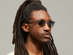 Model is wearing The AYGEN SUN in size 51 in Sage with Forest Wood Tinted Lenses