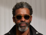 Model is wearing The GATKES SUN in Blonde in size 52 with Denim Blue Tinted Lenses