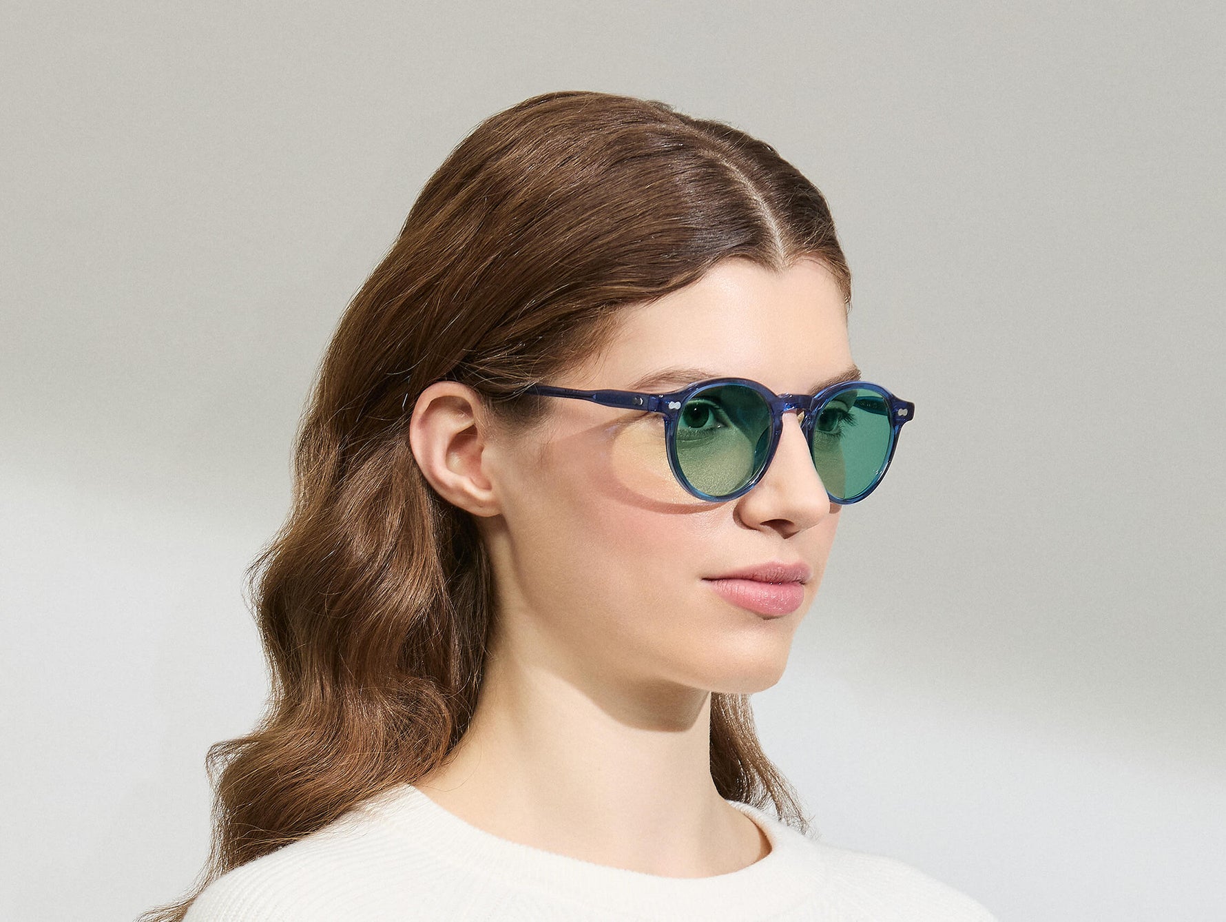 Model is wearing The MILTZEN in Sapphire in size 49 with GREEN+ Lenses