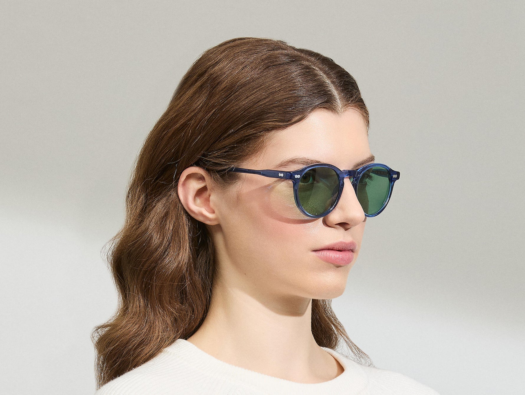 Model is wearing The MILTZEN in Sapphire in size 49 with GREEN+ Lenses
