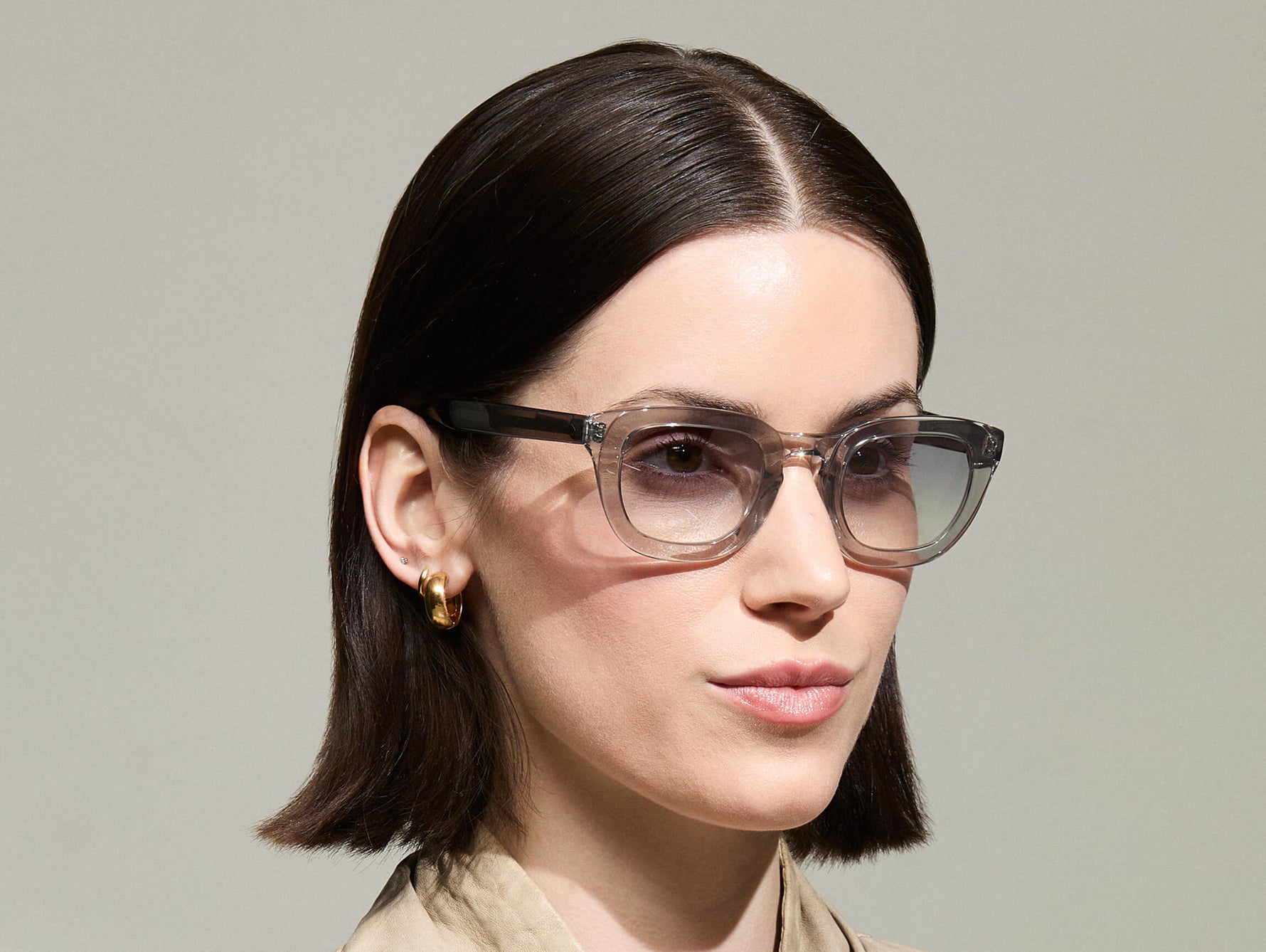 Model is wearing The TELENA in Grey/Light Grey in size 47 with American Grey Fade Tinted Lenses